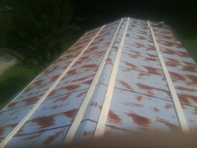 Rusted metal roof panels with new wood purlins before replacement — Storm Damage Roof Repair in Fall Branch by Roofing Brothers